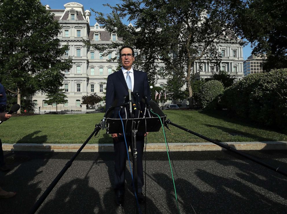PHOTO: U.S. Treasury Secretary Steven Mnuchin speaks to reporters on the North Lawn of the White House on July 24, 2019, in Washington.
