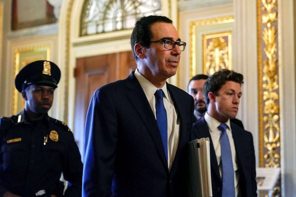 PHOTO: Secretary of the Treasury Steven Mnuchin walks to the meeting with Senate Minority Leader Chuck Schumer during negotiations on a coronavirus disease (COVID-19) relief package on Capitol in Washington, March 23, 2020.