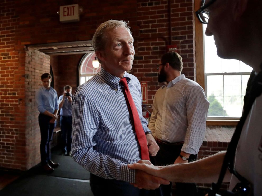 PHOTO: Democratic presidential candidate, businessman Tom Steyer shakes a hand during a campaign event, July 30, 2019, at the Waterworks Cafe in Manchester, N.H.