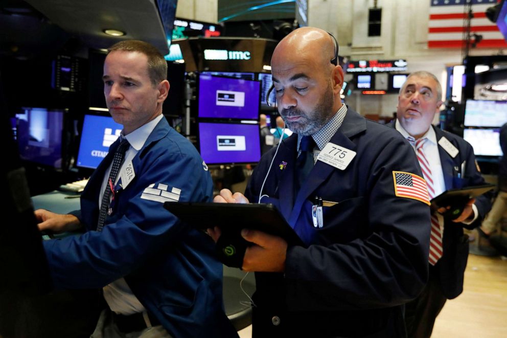 PHOTO: Specialist Stephen Naughton, left, works with trader Fred DeMarco on the floor of the New York Stock Exchange, Aug. 21, 2019.