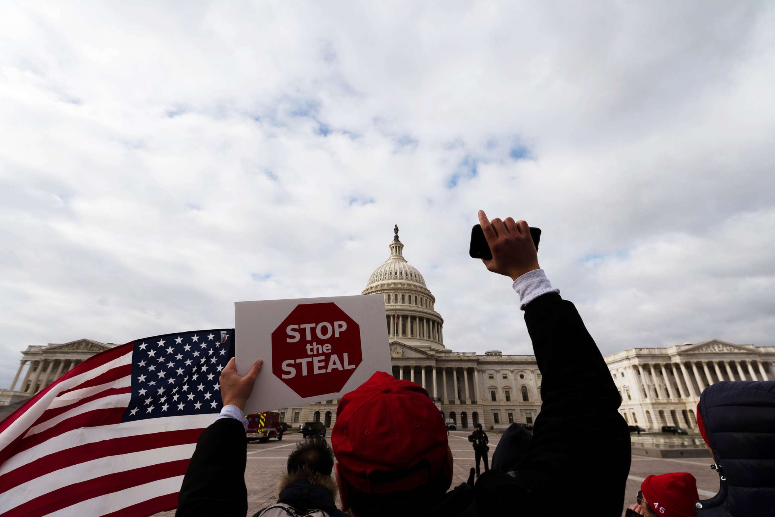 PHOTO: A man with a Stop the Steal sign stands in front of the Capitol Building in Washington, Jan. 6, 2021.