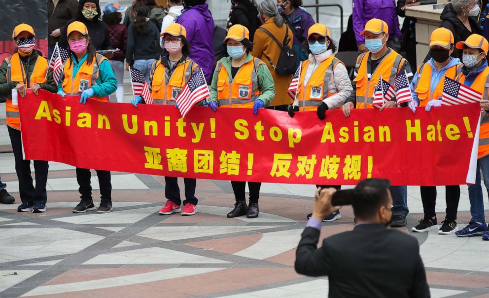 PHOTO: People holding a bilingual banner take part in a Stop Asian Hate rally in Oakland, Calif., May 15, 2021.