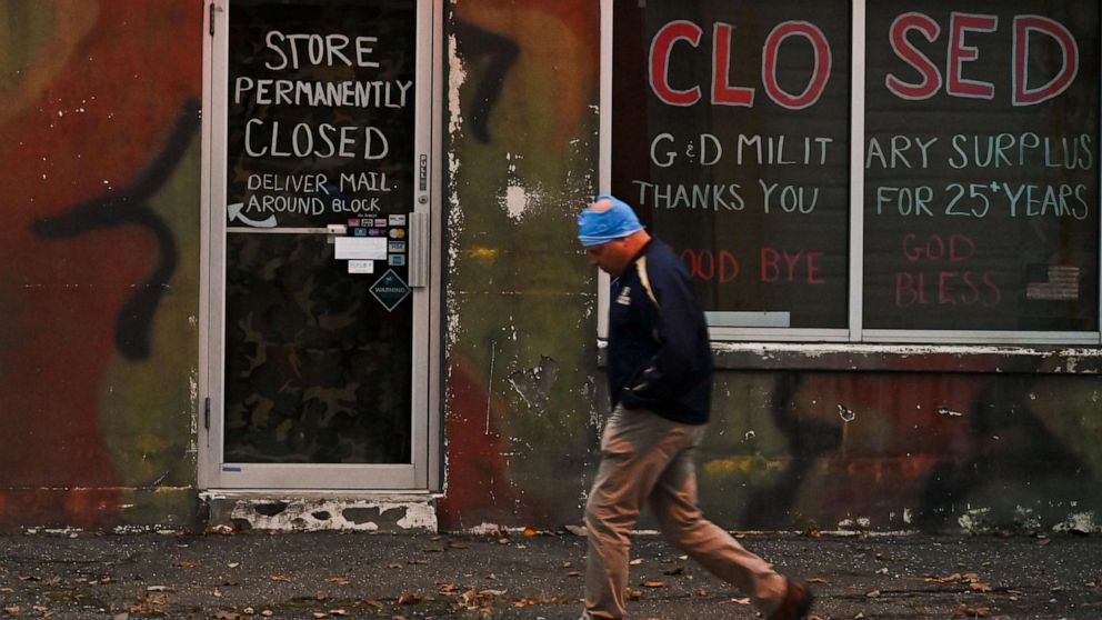 PHOTO: A person passes a closed store in Patchogue, N.Y., on November 12, 2020.