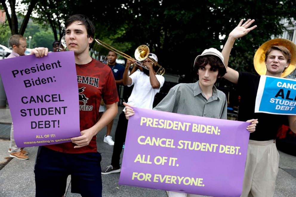 PHOTO: Activists attend a rally outside of the White House to call on U.S. President Joe Biden to cancel student debt in Washington, July 27, 2022.