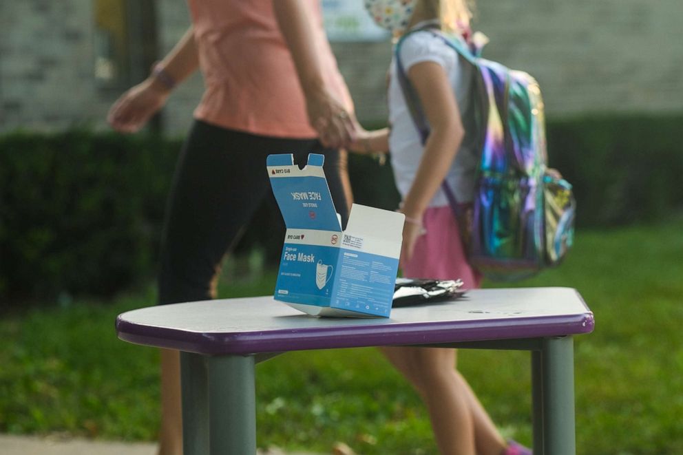 PHOTO: Face masks sit on a table outside of Schoolcraft Elementary for students and parents to wear when entering the building on the first day of school on Aug. 30, 2021, in Schoolcraft, Mich.