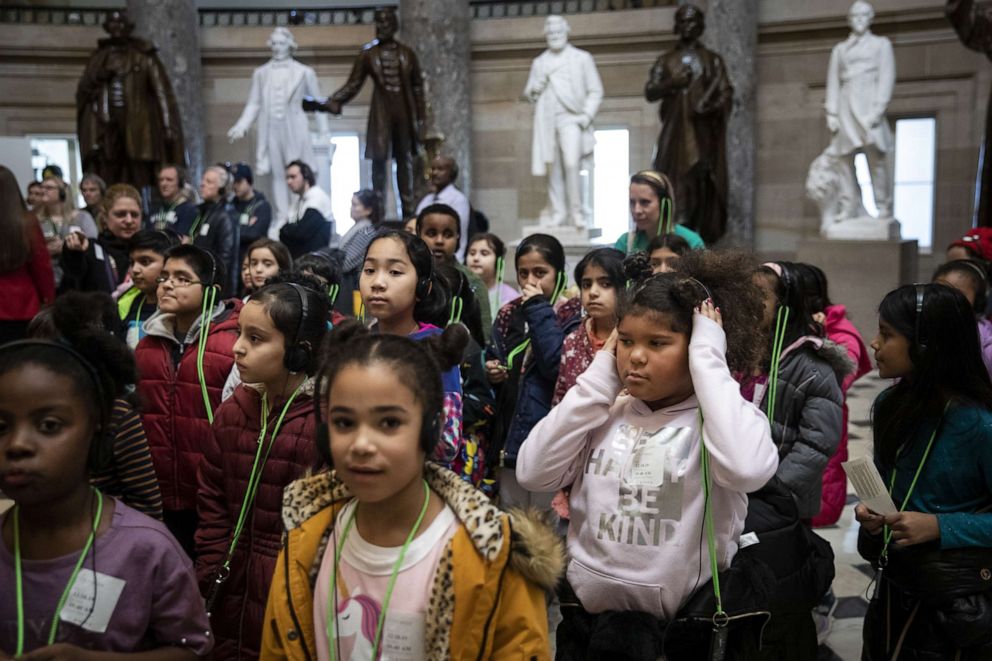 PHOTO: A group of schoolchildren walk through Statuary Hall while on a tour of the U.S. Capitol as debate on the articles of impeachment against President Trump continues on the House floor on Dec. 18, 2019, in Washington.