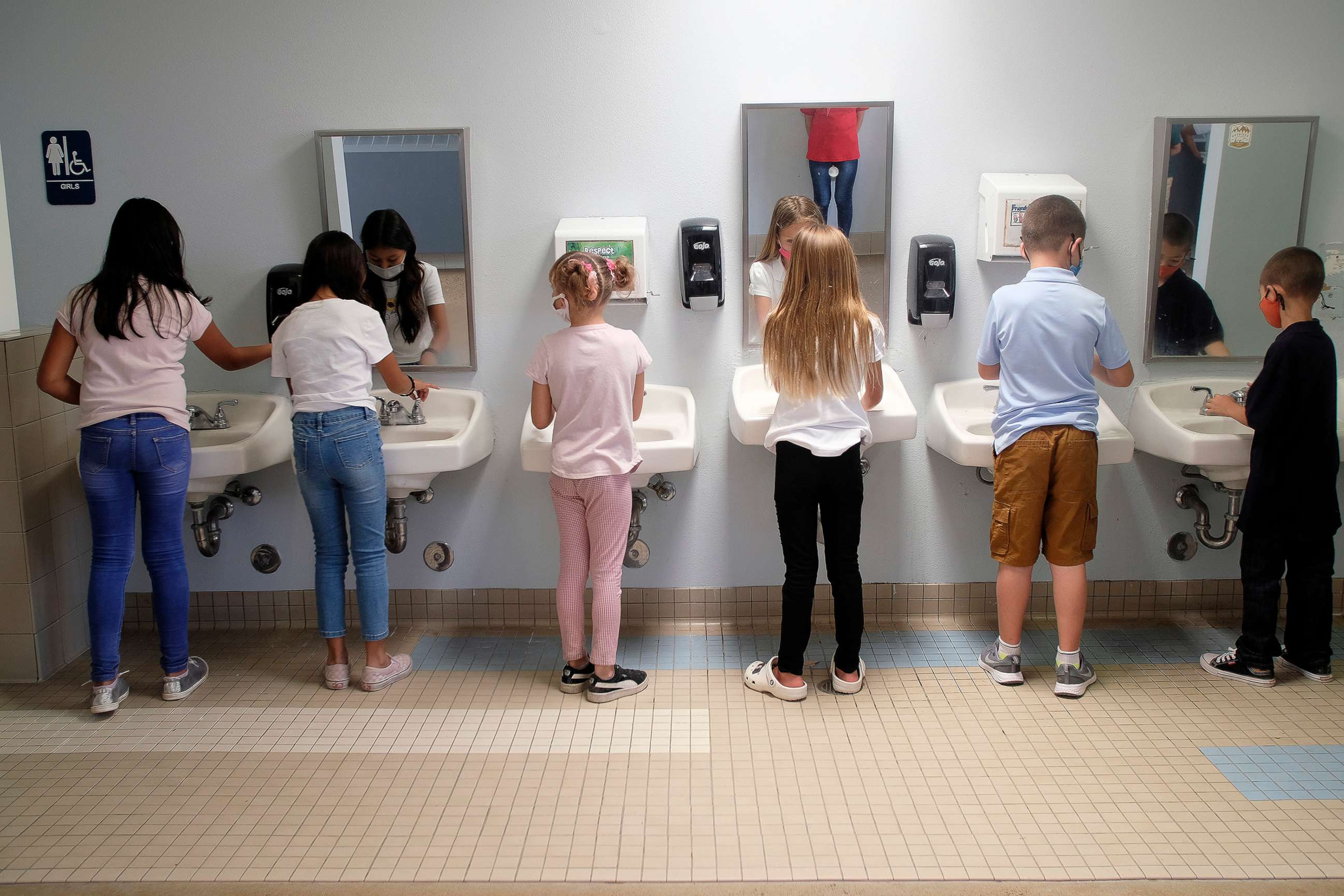 PHOTO: Third graders at Lavaland Elementary School wash their hands after recess before heading back to the classroo, Aug. 4, 2021, in Albuquerque.