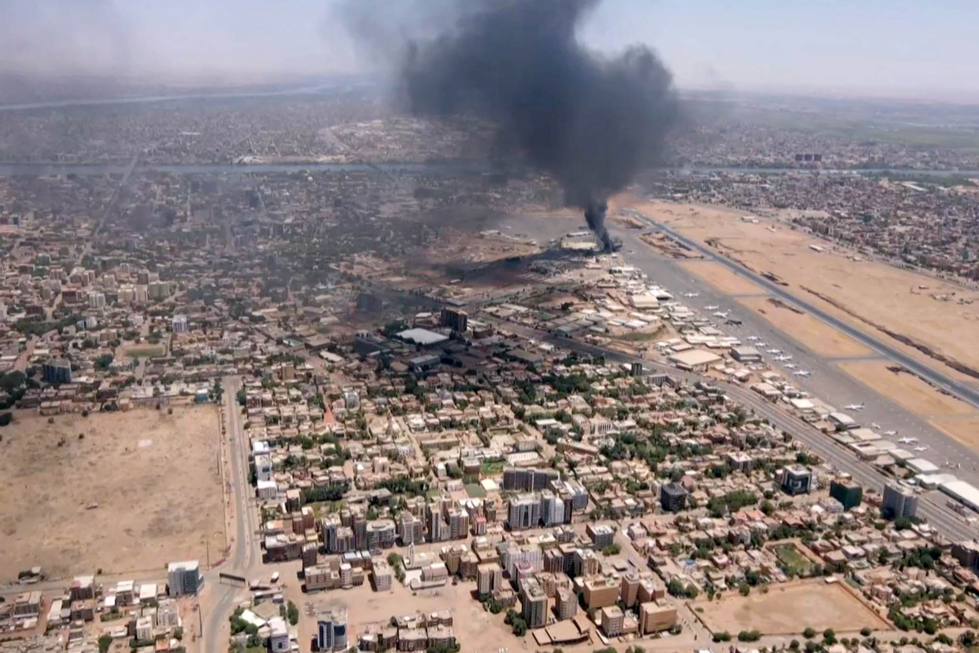 PHOTO: This image grab taken from AFPTV video footage on April 20, 2023, shows an aerial view of black smoke rising above the Khartoum International Airport amid ongoing battles between the forces of two rival generals.