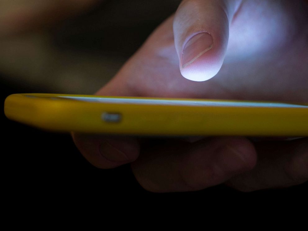 PHOTO: A man uses a cell phone in New Orleans, Aug. 11, 2019.  People in crisis and those trying to help them will have a new three-digit number, 988, to reach the national suicide prevention network starting in July. 