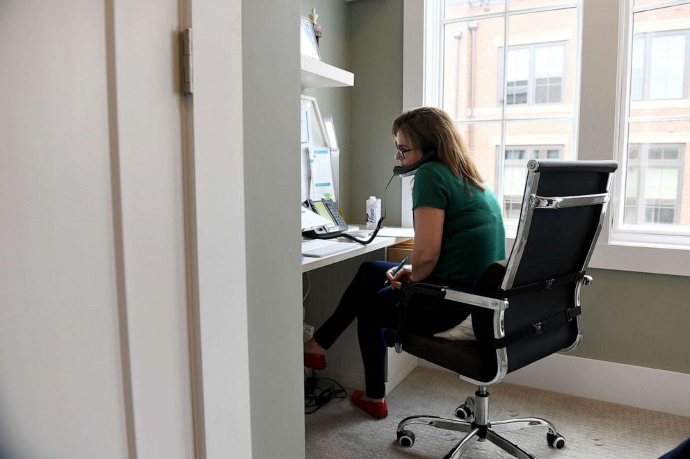 PHOTO: Sue-Ann Siegel takes a call as she works a shift monitoring the Montgomery County Hotline from her home office fielding calls including from the National Suicide Prevention Lifeline, March 18, 2020 in Chevy Chase, MD.