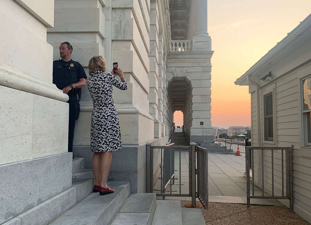 PHOTO: Alaska Republican Lisa Murkowski calls the sunset over the Capitol "snap worthy" and stops to take a photo while waiting for the Senate to proceed on the bipartisan infrastructure bill.