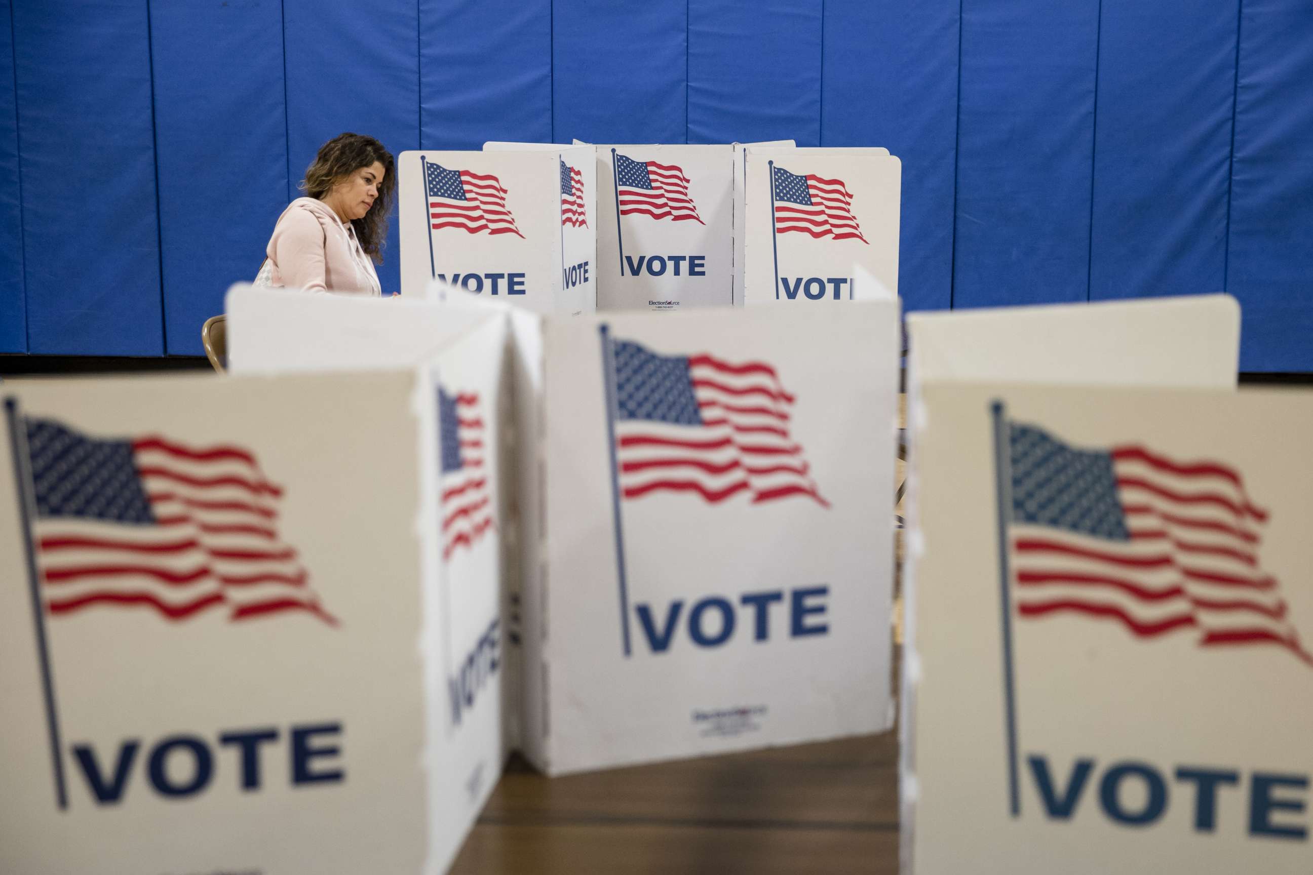 PHOTO: A woman marks down her vote for the Democratic presidential primary election at a polling place in Armstrong Elementary School on Super Tuesday, March 3, 2020, in Herndon, Va.
