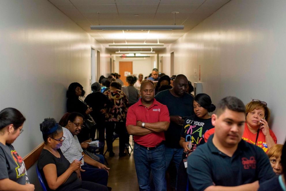 PHOTO: Voters line up at a polling station to cast their ballots during the presidential primary in Houston, Texas on Super Tuesday, March 3, 2020.