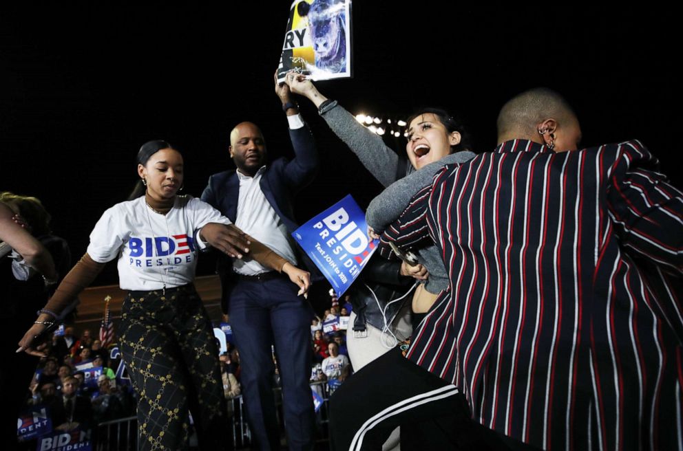 PHOTO: A protester charges the stage holding a sign as Democratic presidential candidate former Vice President Joe Biden speaks at a Super Tuesday campaign event on March 3, 2020, in Los Angeles.