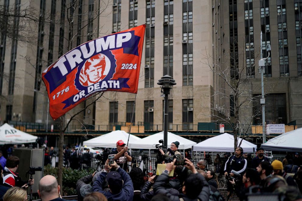 PHOTO: A supporter of former President Donald Trump waves a flag outside Manhattan Criminal Courthouse, on the day of Trump's planned court appearance after his indictment by a Manhattan grand jury in New York City, April 4, 2023.