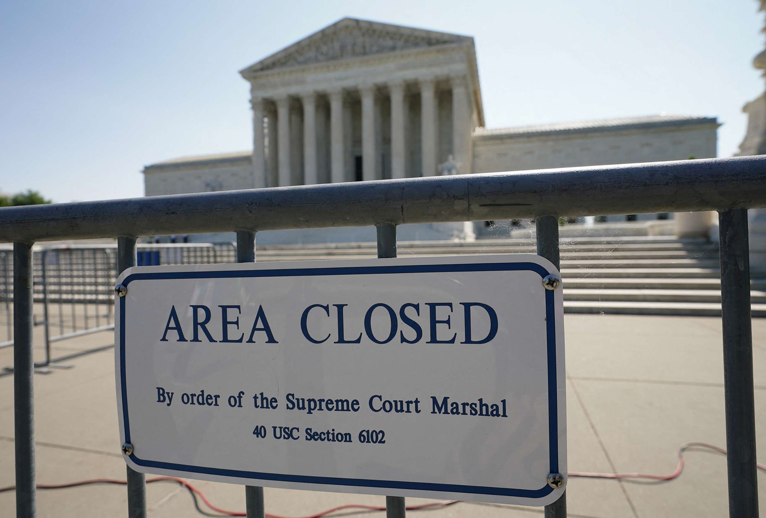 PHOTO: A sign hangs on a security fence in front of the Supreme Court, where today, written opinions in pending, argued cases, are expected to be issued, May 18, 2023.