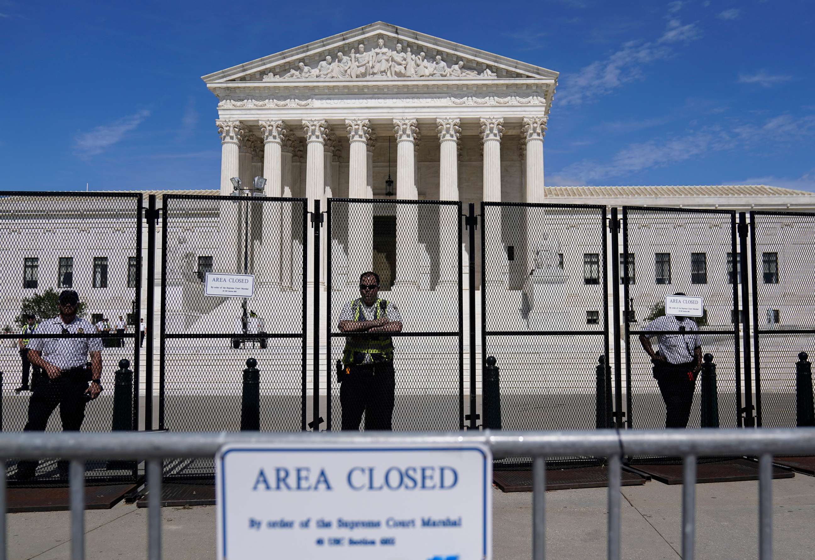 PHOTO: Capitol Police officers stand post behind the temporary anti-scaling fence surrounding the Supreme Court, June 28, 2022.