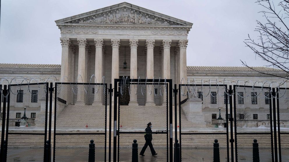 PHOTO: Razor wire topped fencing is seen surrounding the Supreme Court of the United States on Feb. 22, 2021, in Washington, D.C.