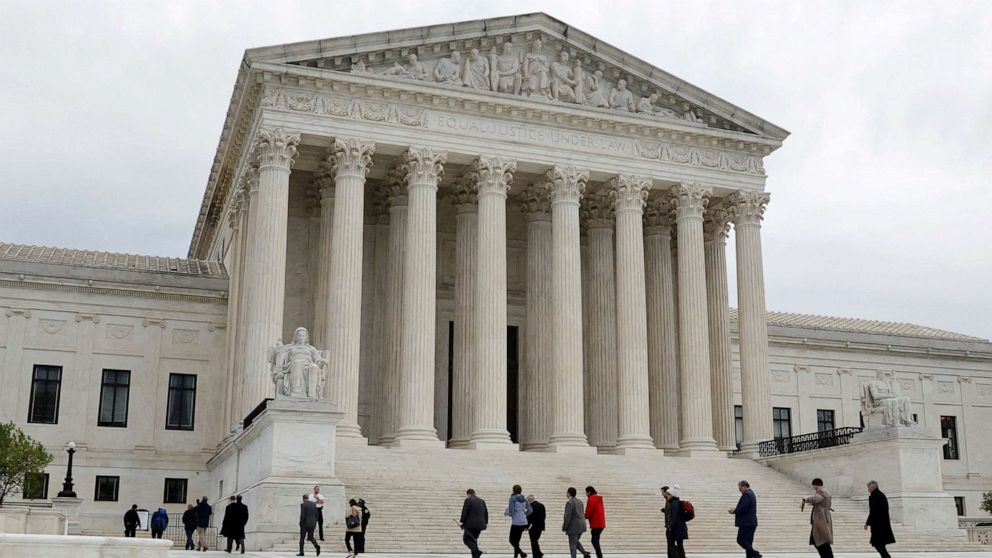 PHOTO: People walk across the plaza of the U.S. Supreme Court building on the first day of the court's new term in Washington, D.C., Oct. 3, 2022. 