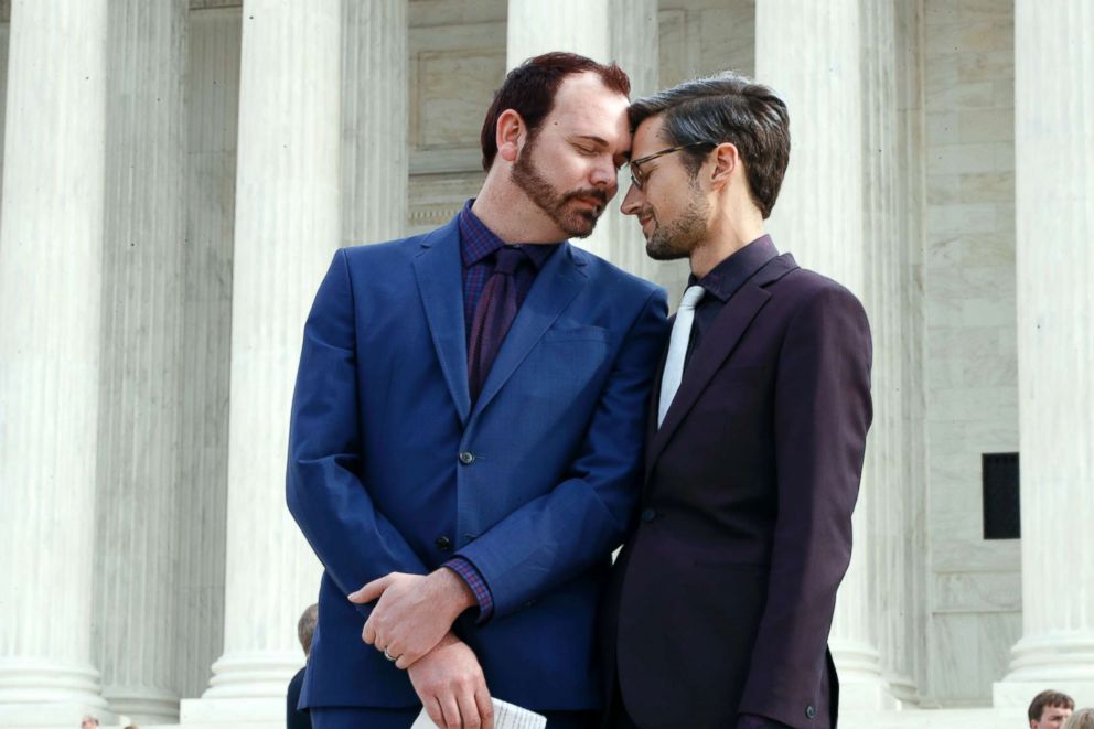 PHOTO: Charlie Craig, left, and David Mullins touch foreheads after leaving the Supreme Court in Washington, DC, Dec. 5, 2017.