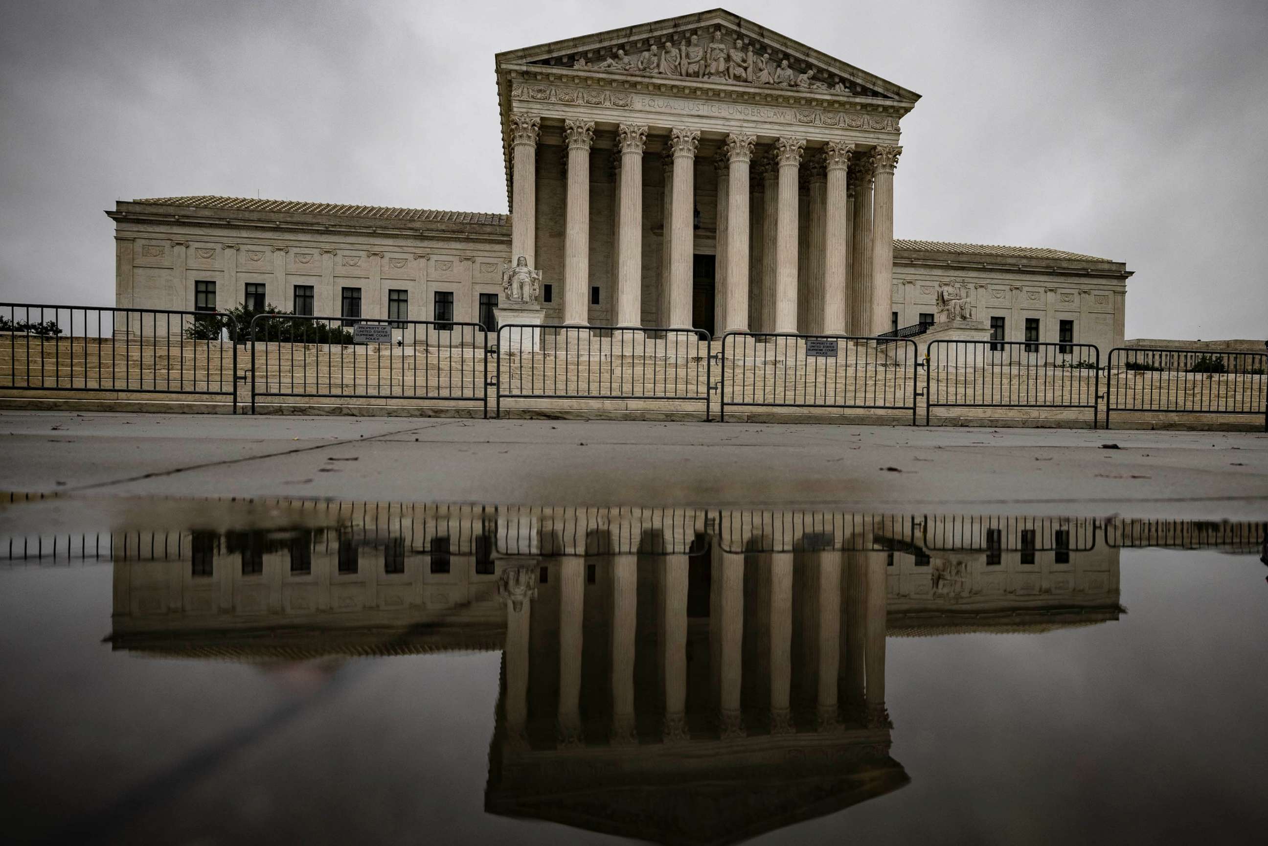 PHOTO: The U.S. Supreme Court is reflected on the wet ground in Washington, Oct. 12, 2020.