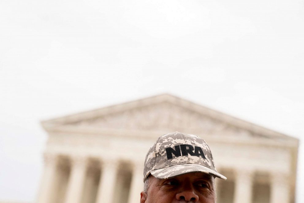 PHOTO: A person wears an NRA hat in front of the US Supreme Court in Washington, DC, on June 21, 2022.