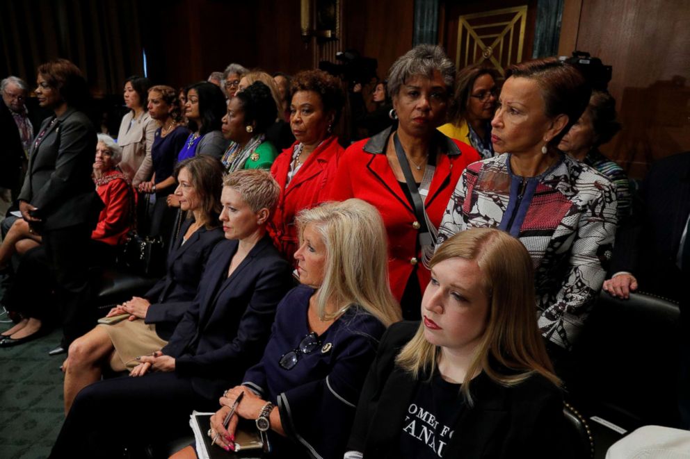 PHOTO: Female members of Congress stand in protest behind seated supporters of U.S. Supreme Court nominee Brett Kavanaugh, as members of the Senate Judiciary Committee meet to vote on Kavanaugh's nomination on Capitol Hill in Washington, Sept. 28, 2018. 