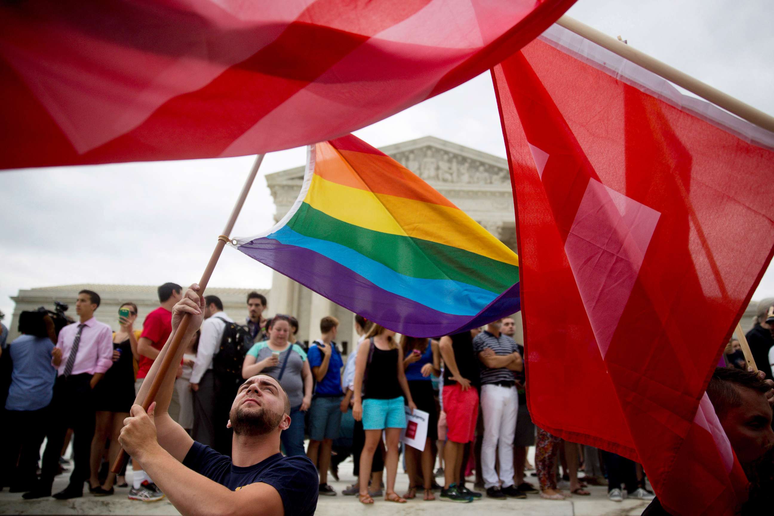 PHOTO: A demonstrator in support of same-sex marriage waves a rainbow colored flag after the same-sex marriage ruling outside the U.S. Supreme Court in Washington, D.C., June 26, 2015.