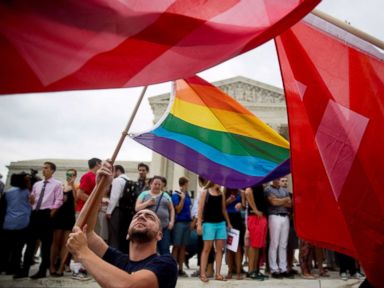 PHOTO: A demonstrator in support of same-sex marriage waves a rainbow colored flag after the same-sex marriage ruling outside the U.S. Supreme Court in Washington, D.C., June 26, 2015.