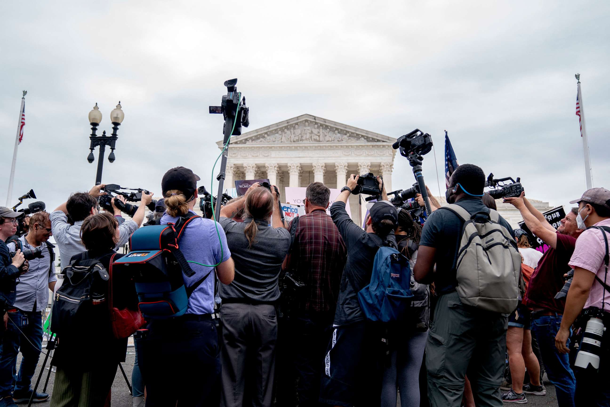 PHOTO: Members of the media gather around demonstrators outside the US Supreme Court in Washington, DC, June 21, 2022.