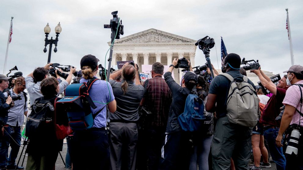 PHOTO: Members of the media gather around demonstrators outside the US Supreme Court in Washington, DC, June 21, 2022.