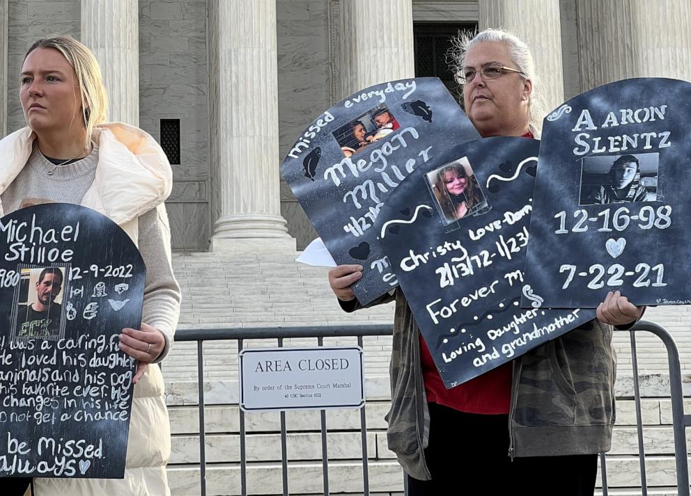 PHOTO: People hold signs of those who have died of opioids during a protest outside the Supreme Court, in Washington, Dec. 4, 2023.