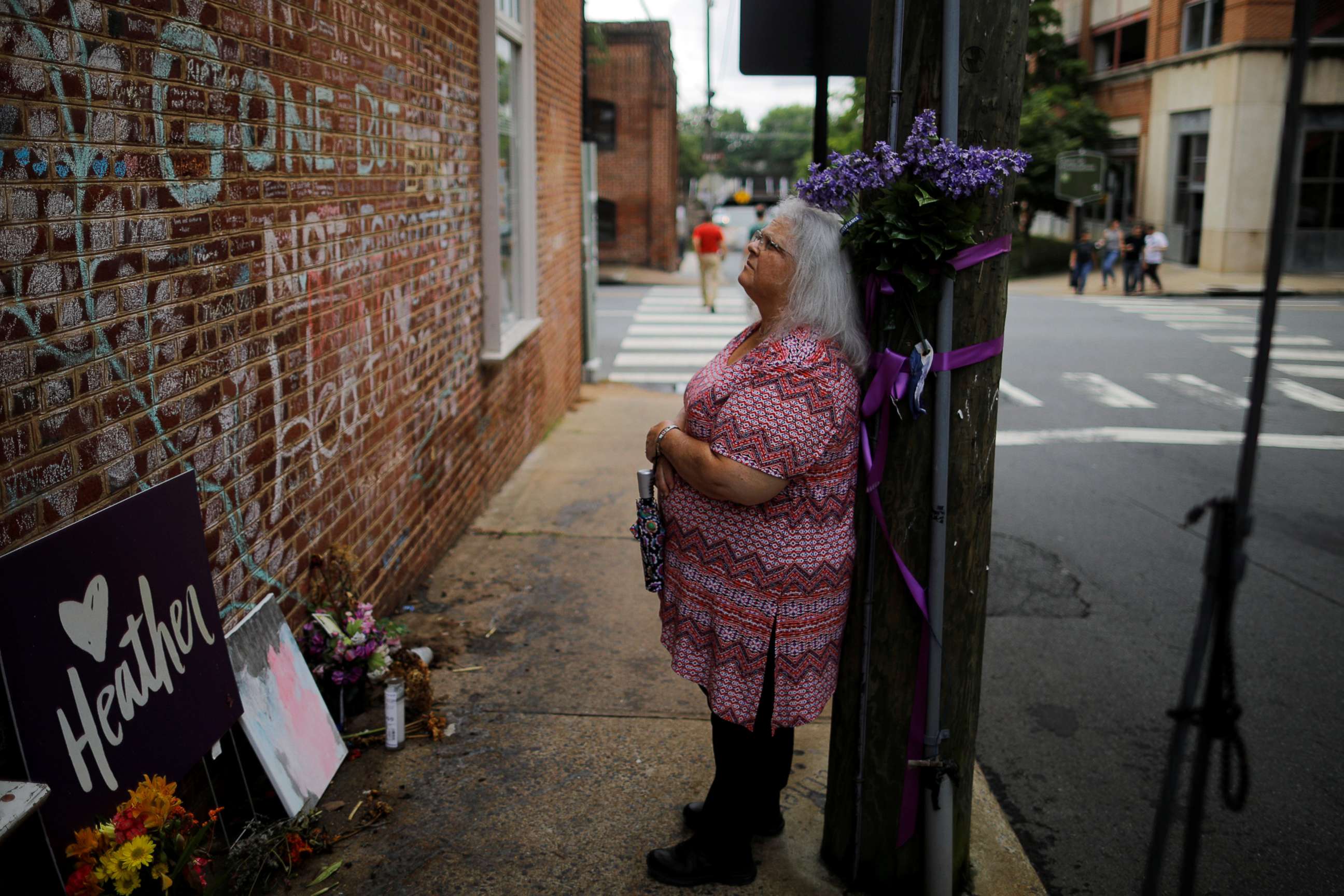 PHOTO: Susan Bro, mother of Heather Heyer, who was killed during the August 2017 white nationalist rally in Charlottesville, stands at the memorial at the site where her daughter was struck by a car in Charlottesville, Va., July 31, 2018.