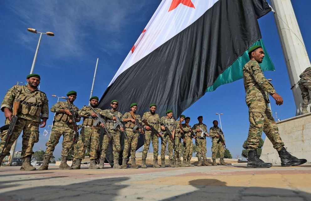 PHOTO: Turkey-backed Syrian fighters take part in a parade in the rebel-controlled town of Tal Abyad in Syria's northern Raqa province, on Oct. 13, 2020.