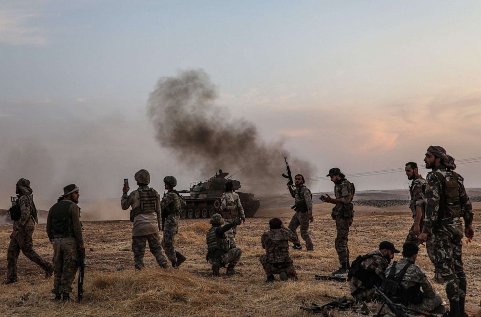 PHOTO: Turkish soldiers and Turkey-backed Syrian fighters gather on the northern outskirts of the Syrian city of Manbij near the Turkish border, Oct. 14, 2019.