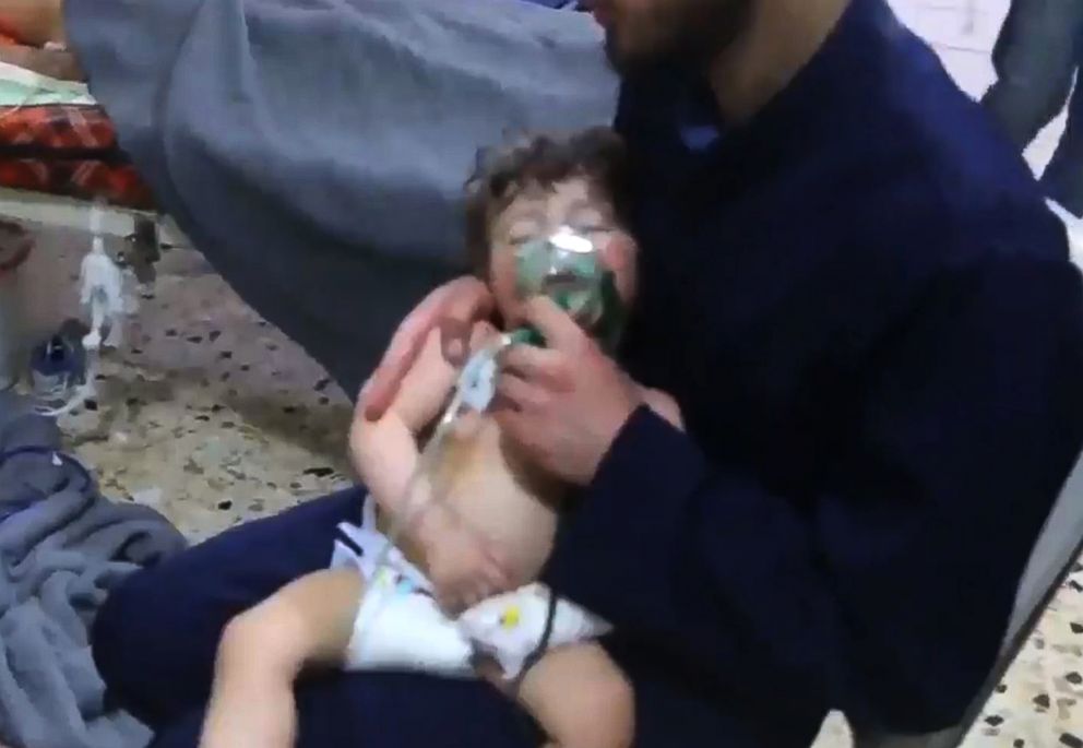 PHOTO: An image grab taken from a video released by the Syrian civil defense in Douma shows an unidentified volunteer holding an oxygen mask over a child's face at a hospital following a reported chemical attack on the rebel-held town, April 8, 2018.