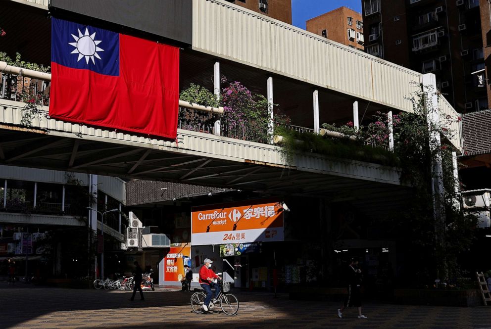 PHOTO: A man cycles past a Taiwan flag in Taipei, Taiwan, Nov. 16, 2021.