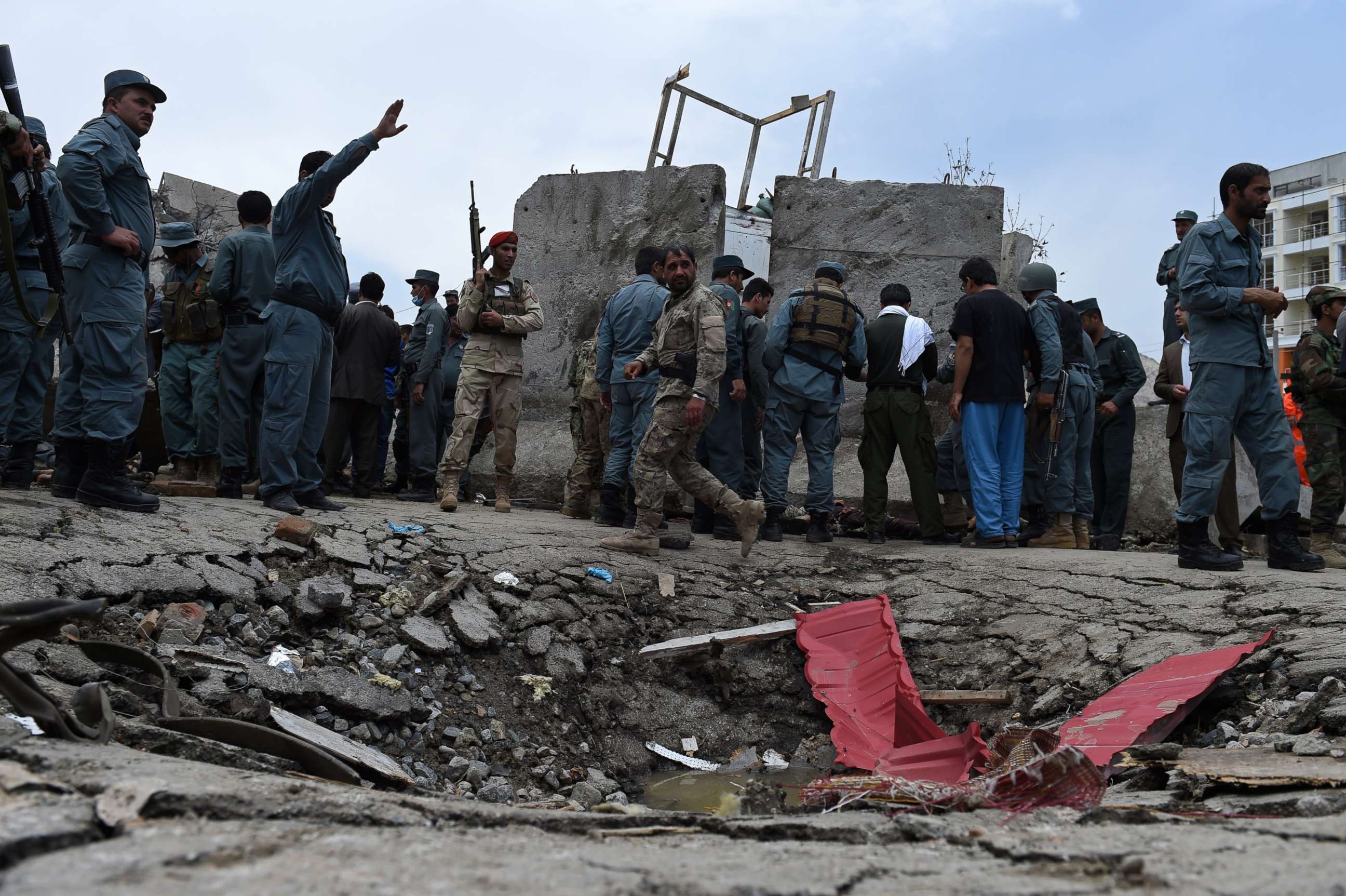 PHOTO: Afghan security personnel stand at the scene of a suicide attack by Taliban militants on the Afghan parliament building in Kabul on June 22, 2015.