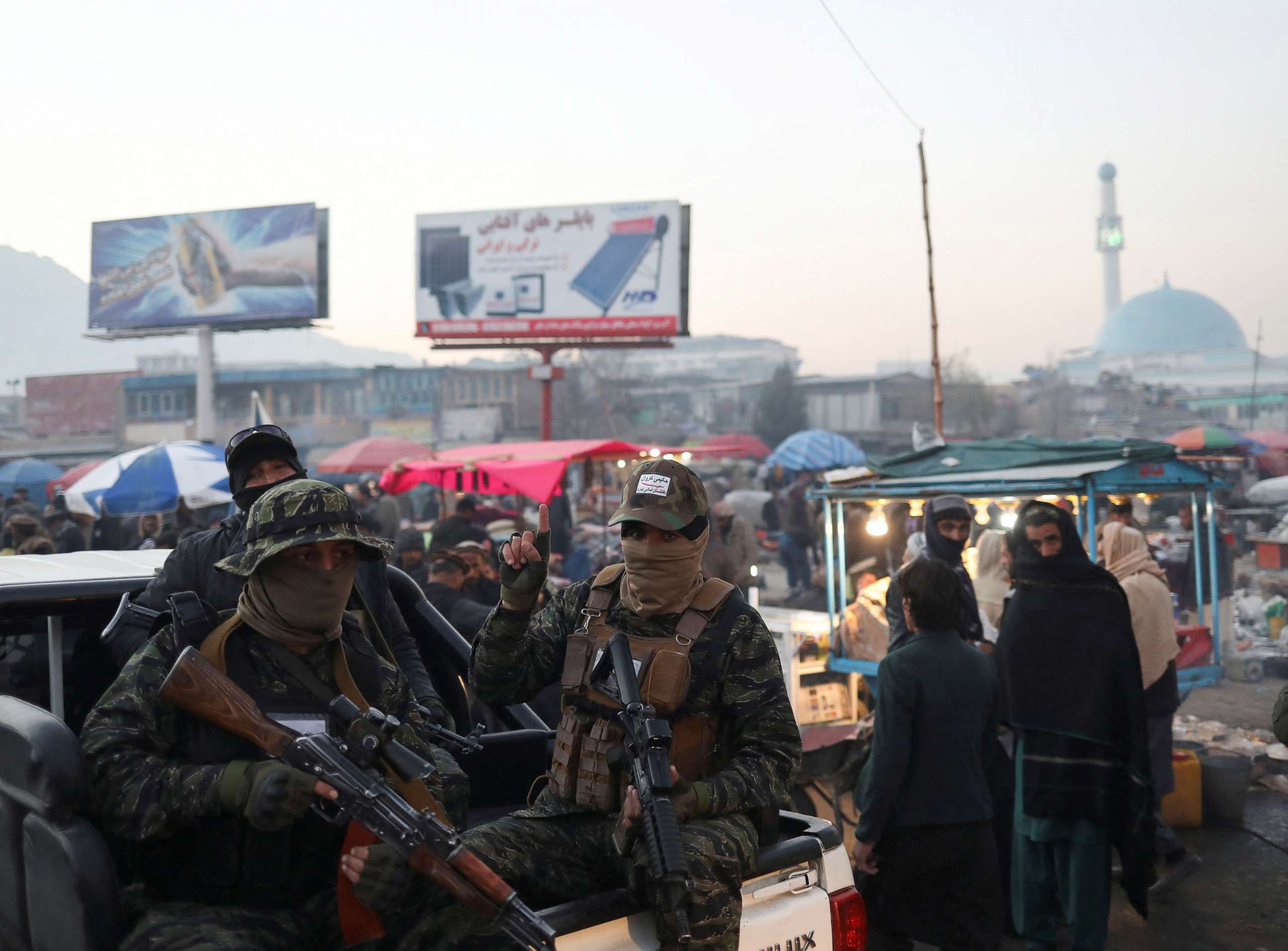 PHOTO: Taliban forces sit in the back of a vehicle as they patrol the city center of Kabul, Afghanistan, Dec. 10, 2021.
