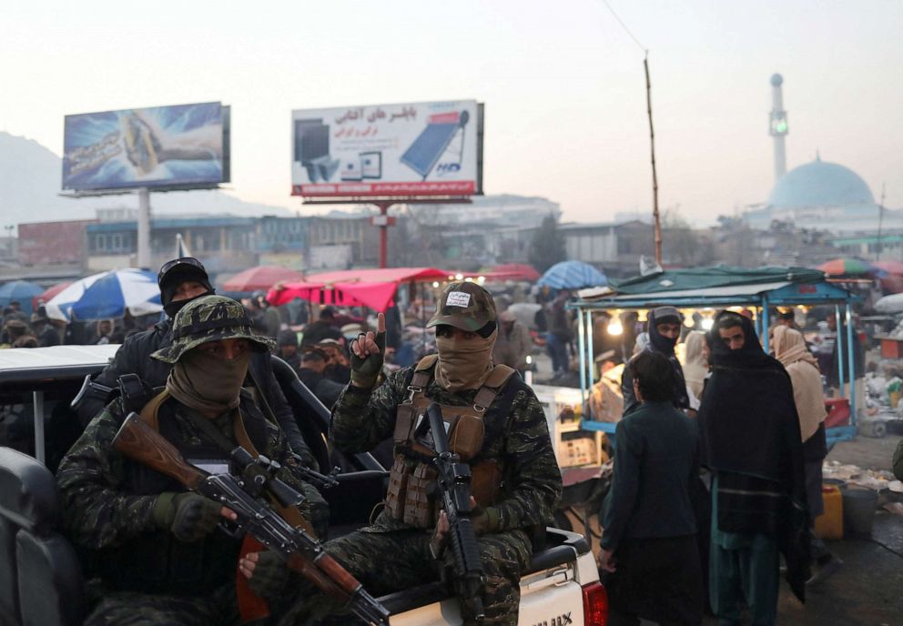 PHOTO: Taliban forces sit in the back of a vehicle as they patrol the city center of Kabul, Afghanistan, Dec. 10, 2021.