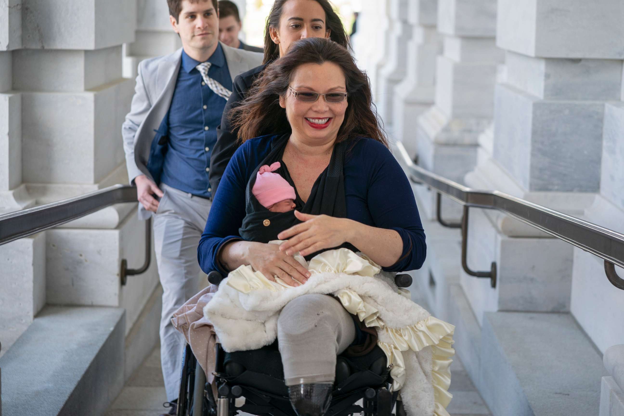 PHOTO: Sen. Tammy Duckworth arrives at the Capitol for vote with her new daughter, Maile, bundled against the wind, in Washington, D.C., April 19, 2018.