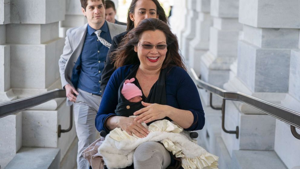 PHOTO: Sen. Tammy Duckworth arrives at the Capitol for vote with her new daughter, Maile, bundled against the wind, in Washington, D.C., April 19, 2018.