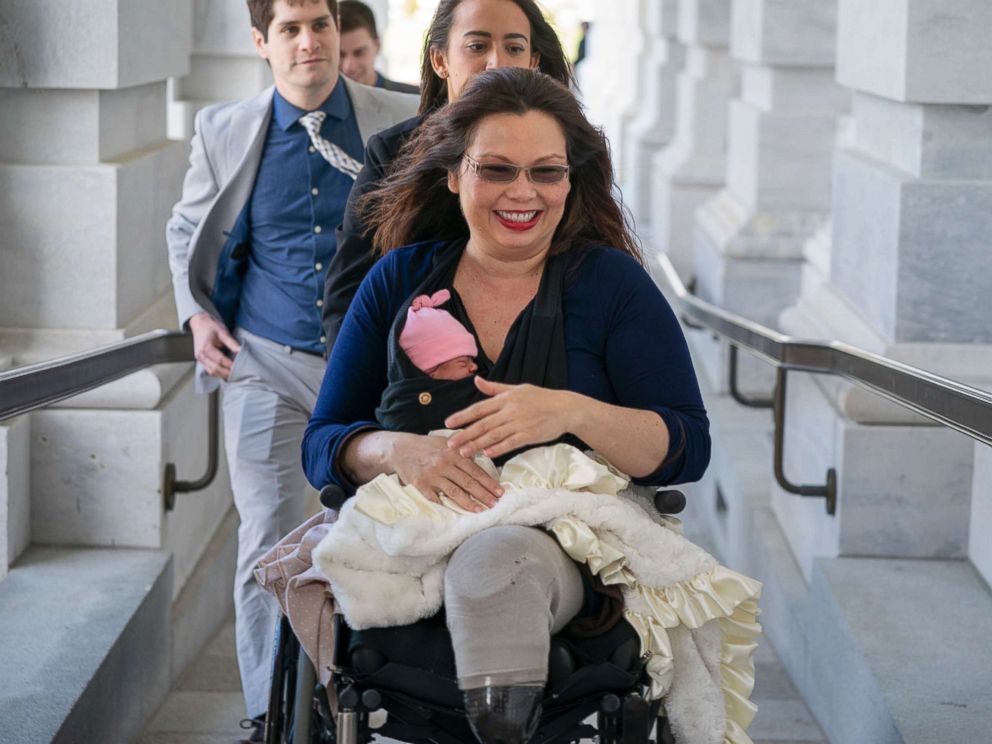 PHOTO: Sen. Tammy Duckworth arrives at the Capitol for vote with her new daughter, Maile, bundled against the wind, in Washington, D.C., April 19, 2018.