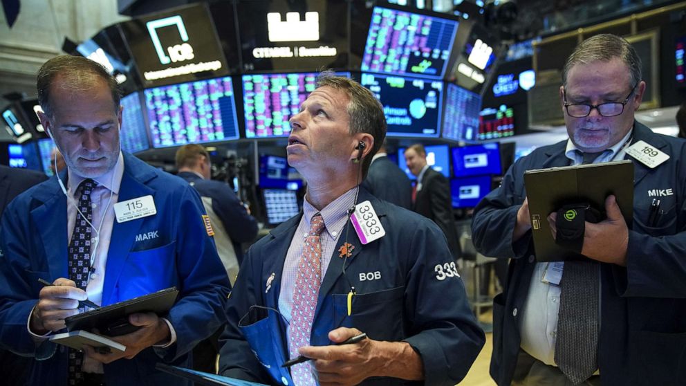 PHOTO: Traders and financial professionals work on the floor of the New York Stock Exchange (NYSE) at the opening bell on August 13, 2019, in New York.