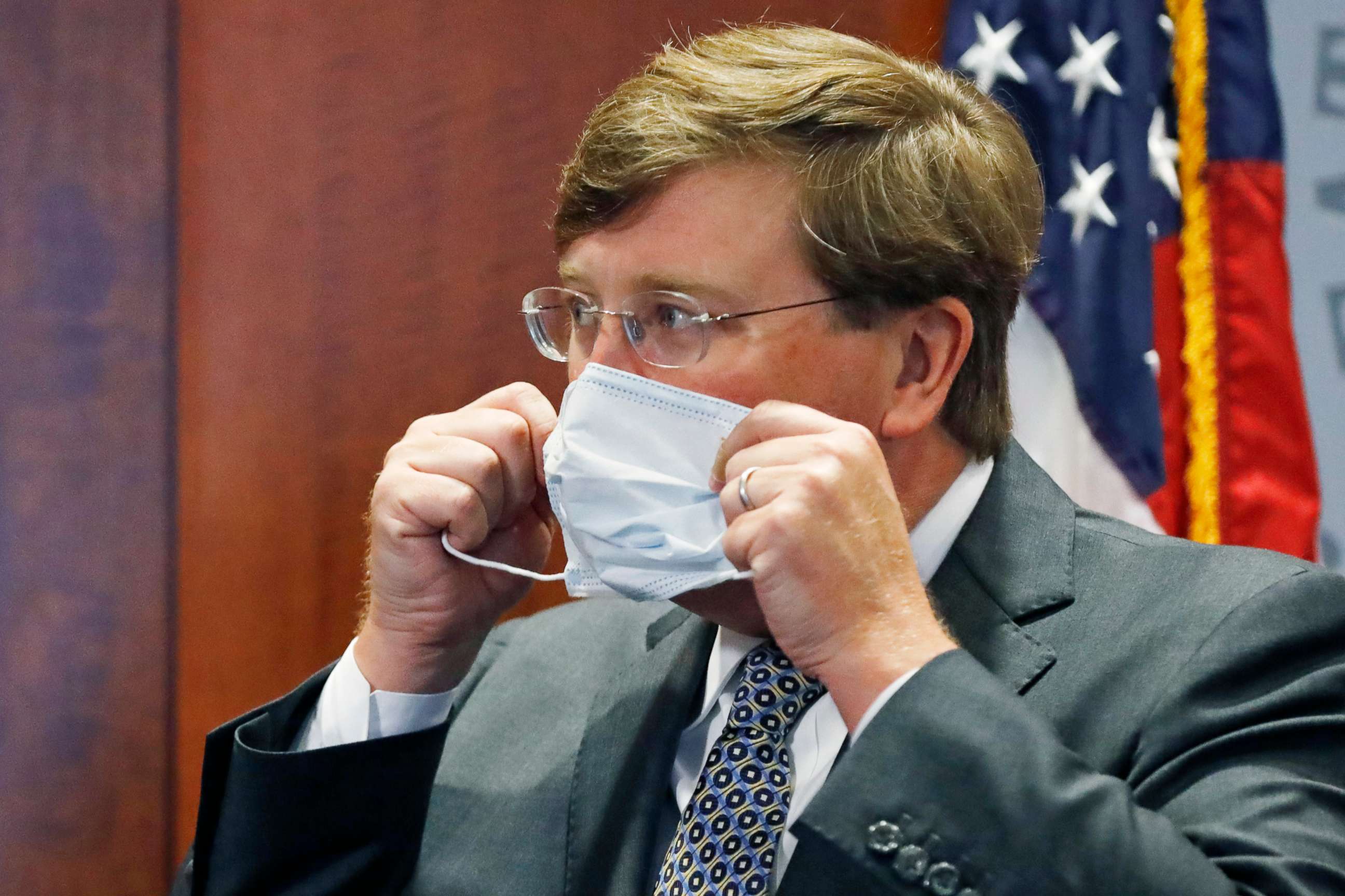 PHOTO: Gov. Tate Reeves adjusts his face mask as he prepares to leave his COVID-19 press briefing, Wednesday, Aug. 5, 2020, in Jackson, Miss. 