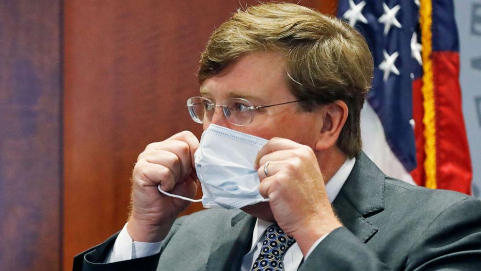 PHOTO: Gov. Tate Reeves adjusts his face mask as he prepares to leave his COVID-19 press briefing, Wednesday, Aug. 5, 2020, in Jackson, Miss. 