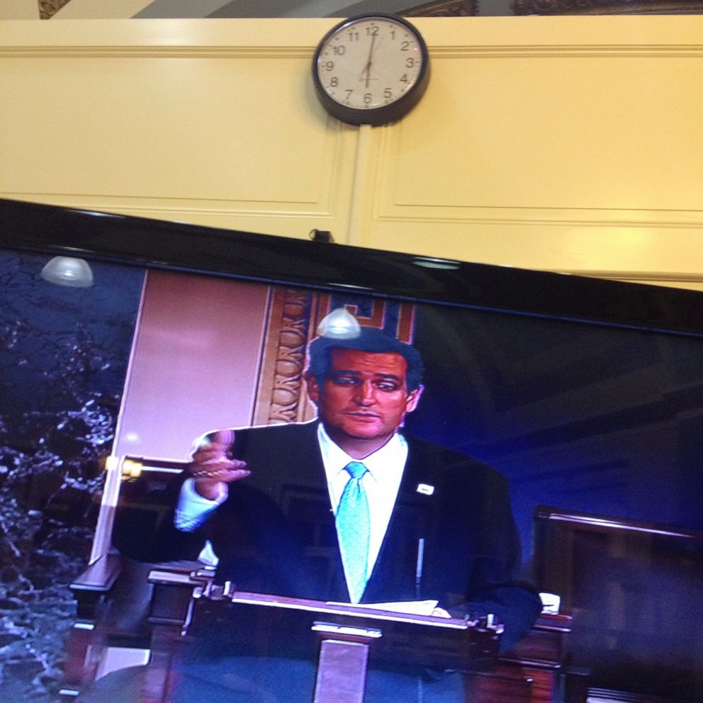 PHOTO: Sen. Ted Cruz is seen on a television screen in the Senate Press Gallery as he speaks during the 15th hour of his filibuster on the Senate floor at the U.S. Capitol in Washington, Sept. 25, 2013.