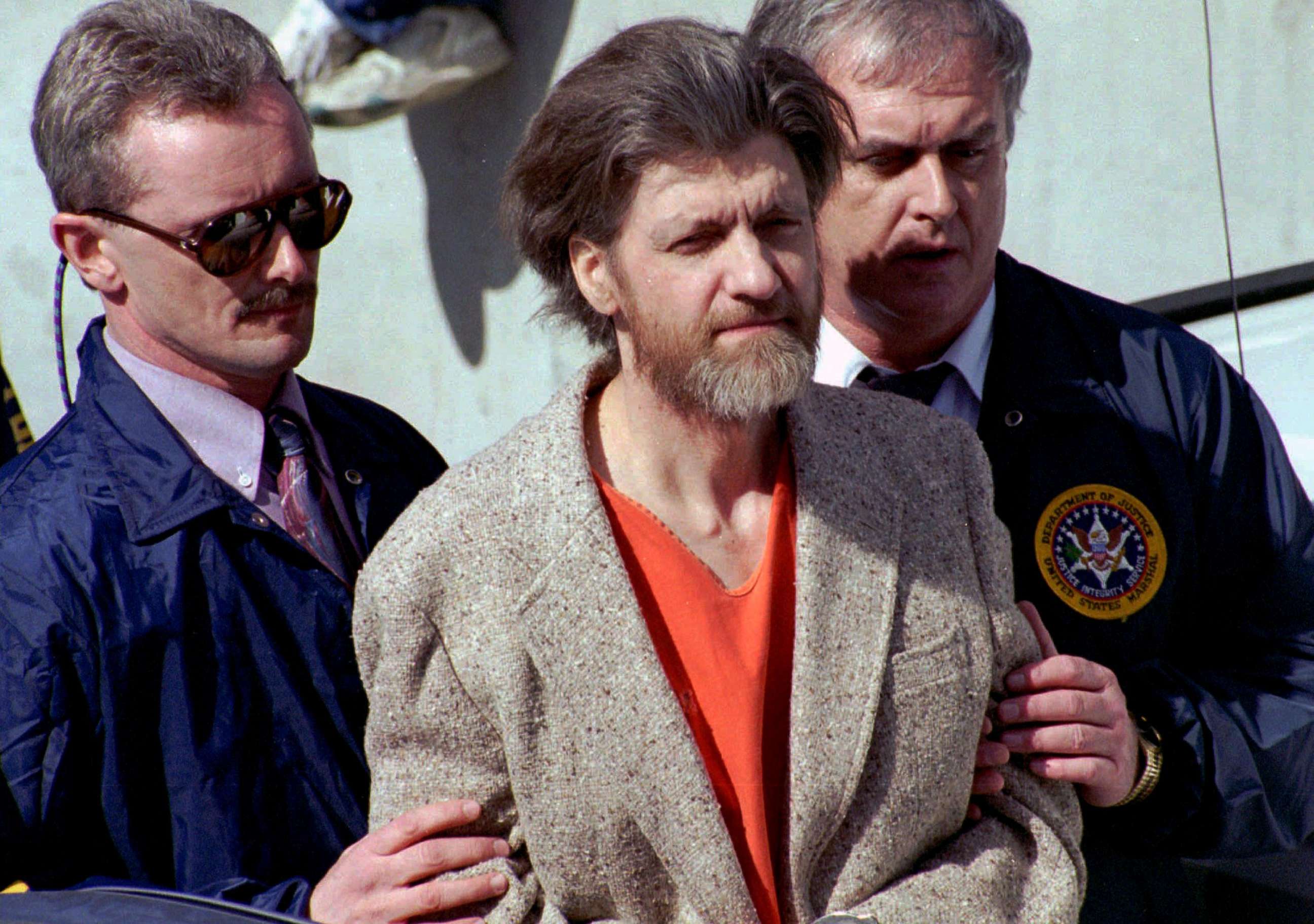 PHOTO: In this April 4, 1996 file photo, Ted Kaczynski, better known as the Unabomber, is flanked by federal agents as he is led to a car from the federal courthouse in Helena, Mont.