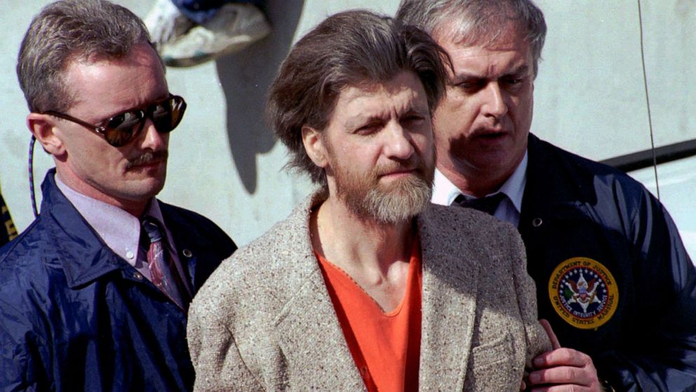 PHOTO: In this April 4, 1996 file photo, Ted Kaczynski, better known as the Unabomber, is flanked by federal agents as he is led to a car from the federal courthouse in Helena, Mont.
