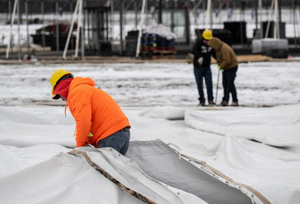 PHOTO: Workers break down parts of the tents set outside for the inauguration of President-elect Donald Trump, in Washington, D.C., on Jan. 18, 2025.